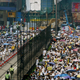 Protesters crowd a street at Hong Kong's Causeway Bay shopping district during a march July 1, 2004 on the seventh anniversary of the the handover of Hong Kong to China. Tens of thousands of Hong Kong people dressed in white poured onto the streets on Thursday to vent their frustration at Chinese rule and challenge Beijing's refusal to allow them to elect their own leaders